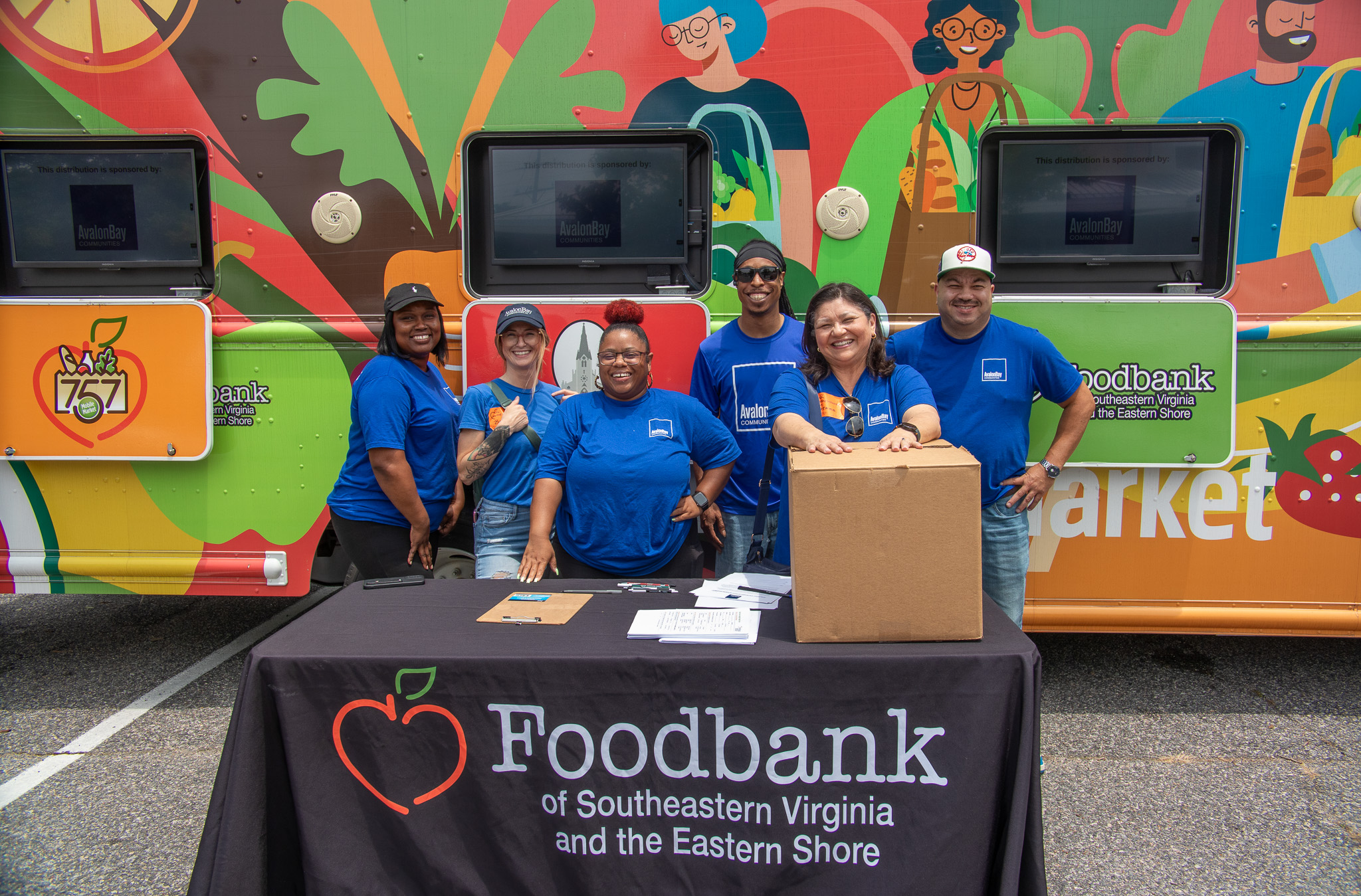 Food pantry volunteer assisting with meal distribution for families Food bank volunteer sorting canned goods at donation center