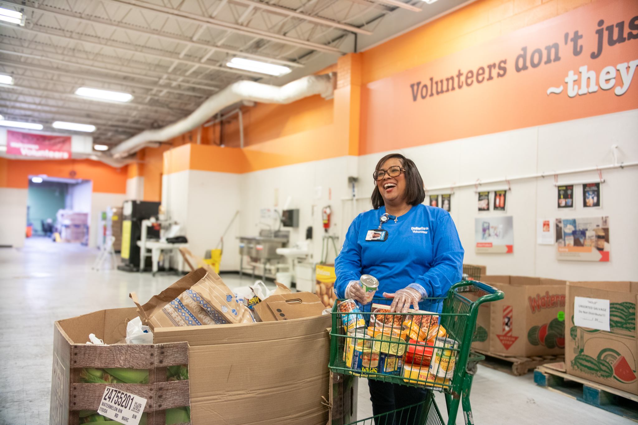 Food pantry volunteer helping Group exploring food bank volunteer opportunities in Virginia